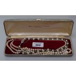 A 2-colour pearl necklace with silver clasp, a single-strand pearl necklace with 14ct gold clasp,