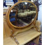 An Edwardian mahogany oval swing toilet mirror