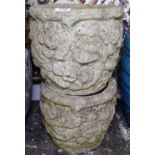 A pair of weathered textured concrete garden planters