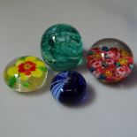 A collection of glass paperweights, including Caithness and Murano