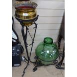 Brass planter on wrought-iron stand, and a greed bottle in stand