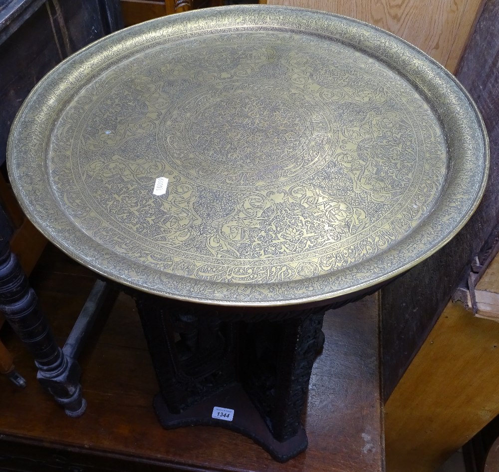 An Indian carved hardwood circular table, with engraved brass top, 51cm - Image 2 of 2