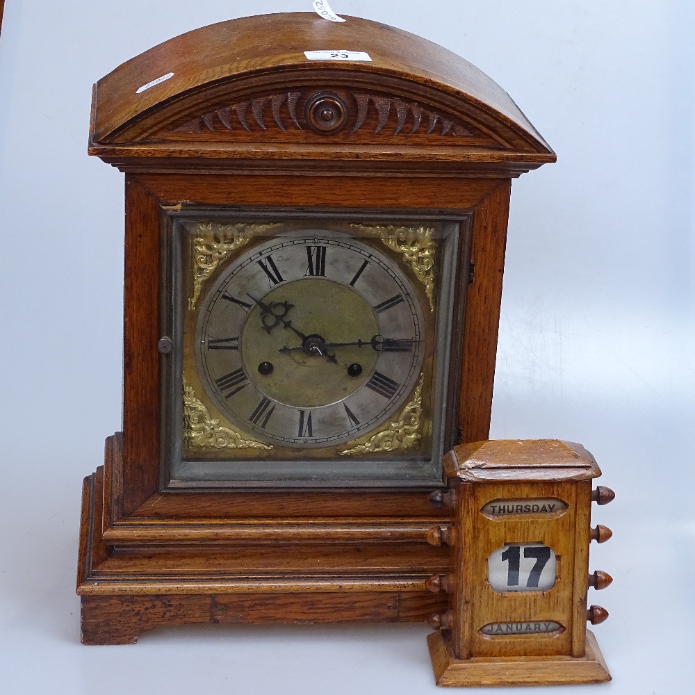 An oak perpetual calendar, and an oak-cased mantel clock with 2-train movement, height 15"