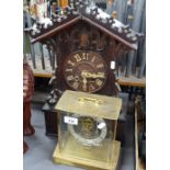 A Black Forest carved wood mantel clock, height 18", and a German Kundo clock