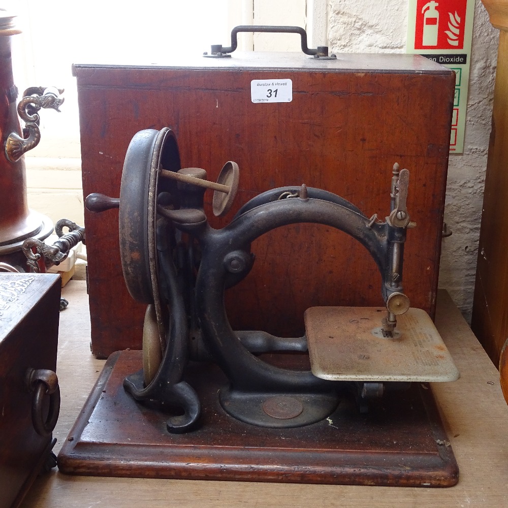 A Willcox & Gibbs sewing machine with original case