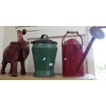 A watering can, a pail and cover, and a large elephant