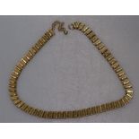 A stylised 9ct gold panel necklace, 19.8g