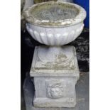 A painted concrete garden urn on pedestal base, H75cm