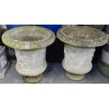 A pair of large weathered embossed concrete garden urns, H70cm, W60cm