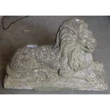 A weathered concrete recumbent lion, L60cm