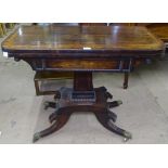 A Regency rosewood and satinwood-banded foldover card table, raised on a tapered centre column,