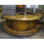 A large industrial polished pine drum design coffee table, W109cm, H52cm