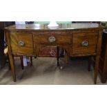 A Georgian mahogany knee-hole sideboard of bow-front form, with central drawer flanked by panelled