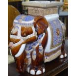 A pair of glazed ceramic elephant seats