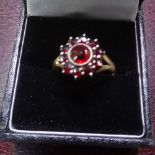 An 18ct gold facet-cut garnet cluster ring, setting height 13.4mm, size S, 3.3g