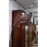 A chrome and marble-base floor arch lamp