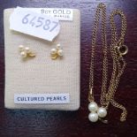 A 9ct gold and cultured pearl pendant on a 9ct gold chain, and a pair of matching earrings