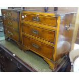 A pair of reproduction yew wood Campaign style bedside chests, of 3 long drawers, with recessed