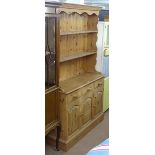 A modern polished pine 2-section kitchen dresser, W122cm, H205cm