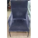 A contemporary armchair with velvet upholstery