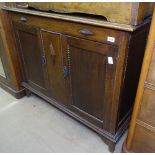 A 1920s oak sideboard, with 2 panelled doors, W112cm, H91cm