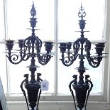 A pair of embossed cast-metal 5-branch candelabra, with urn design, height 68cm