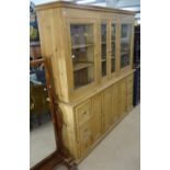 A large polished pine 2-section kitchen dresser, L216cm, H214cm