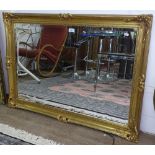 A modern giltwood bevelled-edge wall mirror