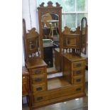 An Art Nouveau oak drop-centre triple-mirror dressing table, with short and fitted long drawers,