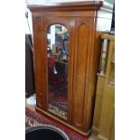 A Victorian mahogany round-cornered compactum wardrobe, with a single arch-top glazed pinn door,