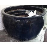 A graduated set of 3 black glazed garden plant pots, widest 50cm