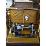 A Vintage Standard sewing machine, a teak cantilever sewing cabinet, and another