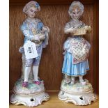 A pair of 19th century German porcelain country figures, height 28cm