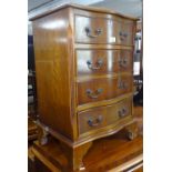 A reproduction serpentine-front yew wood chest of 4 short drawers, W50cm, H70cm