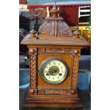 A carved oak-cased 2-train mantel clock, 42cm