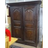 An 18th century oak armoire, with 2 carved and fielded panelled doors (A/F), W155cm, H196cm, and