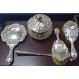 A 4-piece silver-backed dressing table brush and mirror set, with shoe horn, and a large matching