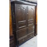 A 19th century oak 2-section cupboard, with fielded panel cupboard doors, and drawers to the base,