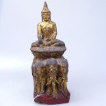 A 19th century Burmese carved giltwood Buddha, supported by 3 elephants, height 31cm