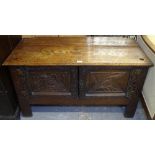 An oak low cabinet with 2 carved panelled doors, W108cm