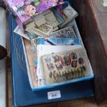 A postcard album, cigarette cards, and wartime postcards etc