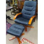 An upholstered swivel armchair and matching footstool