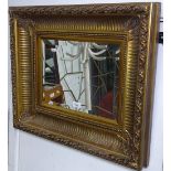 An ornate gilt cushion-framed bevelled-edge wall mirror, W66cm, H55cm