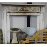 An Antique painted pine fire surround, with ribbon and bow decorated frieze, W140cm, H131cm,
