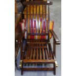 A stained teak folding steamer chair with loose cushion