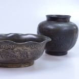 A Chinese bronze pot with floral panels, height 9.5cm. and a Chinese bronze bowl