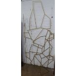 A Brutalist cut-steel folding skeleton 3-panel screen