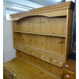 A modern polished pine kitchen 2-section dresser, top having open plate rack with fitted spice