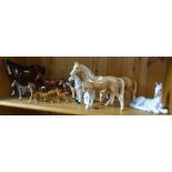 A shelf of horse ornaments