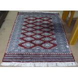 A small red ground Tekke rug, 130cm x 100cm
